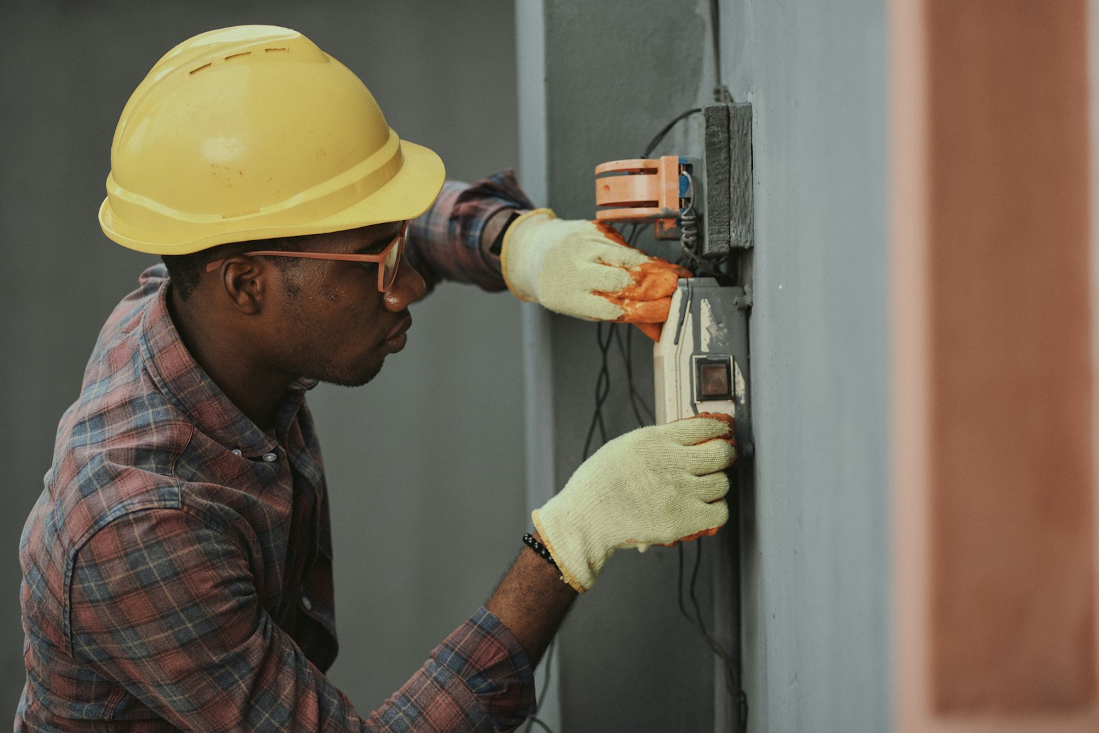 Licensed technician inspecting door opener wiring during a home service call