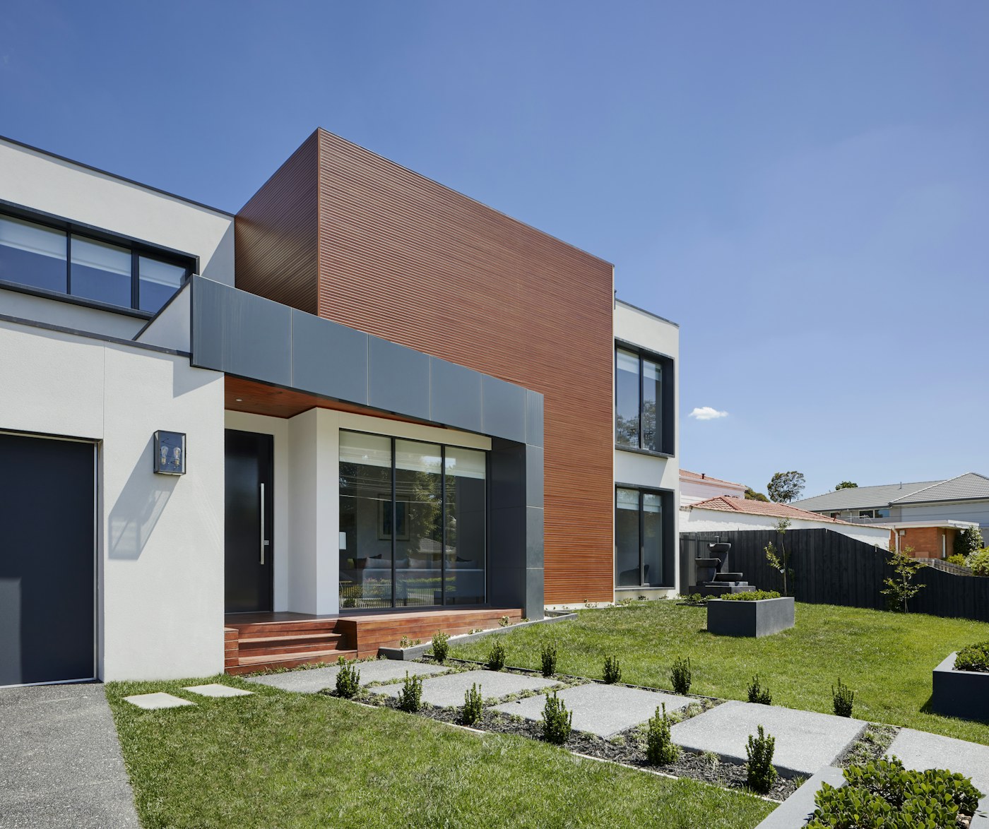 Modern charcoal garage door on a new-build home — curb appeal and insulation, installed in one visit