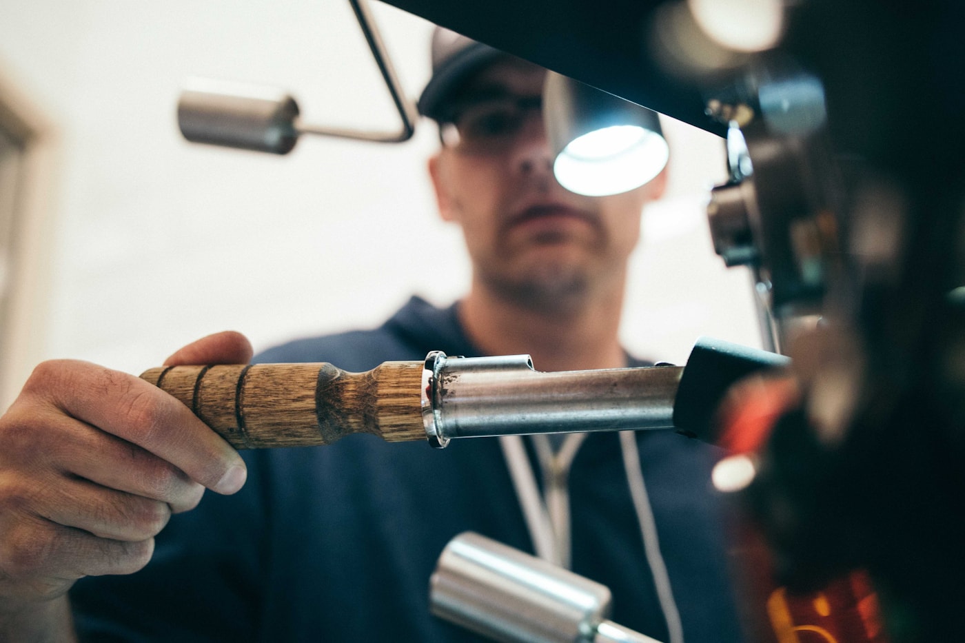 Technician fine-tuning garage door hardware on site — spring replacement takes precision, not guesswork